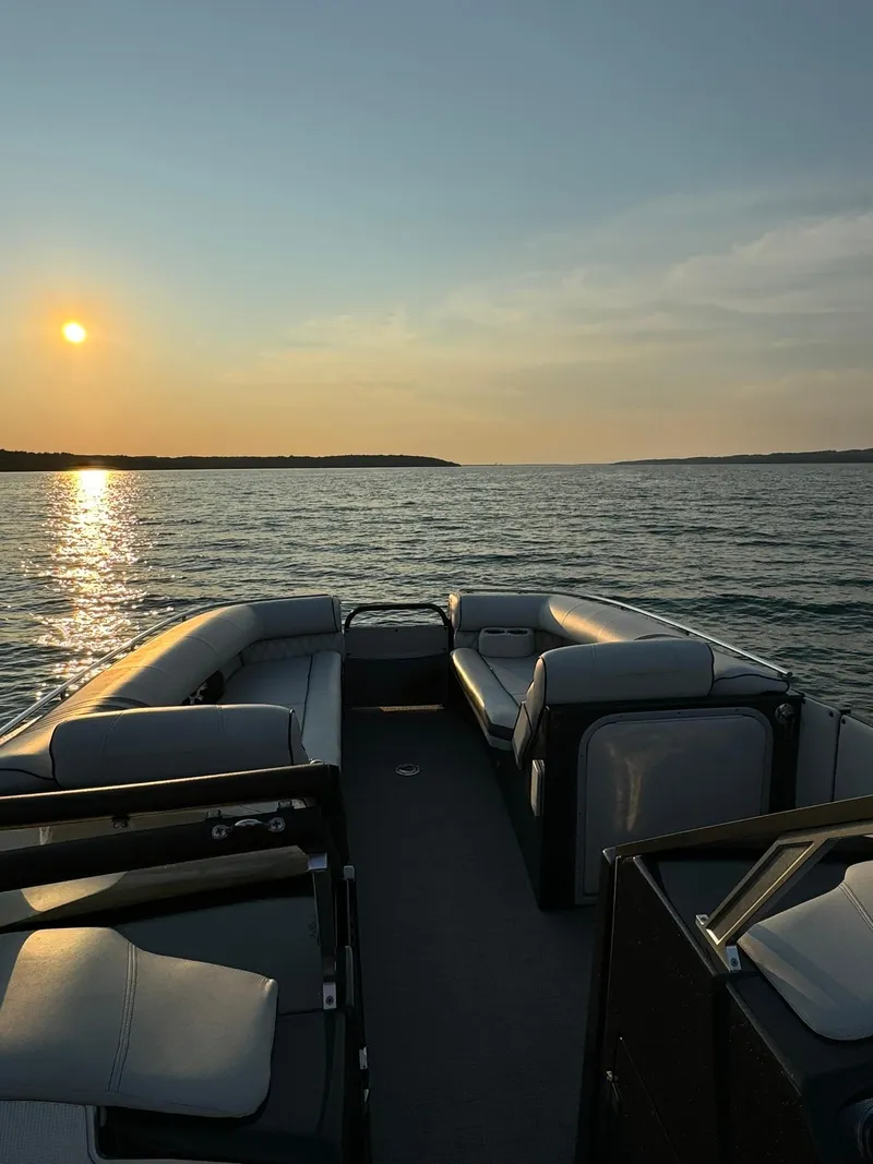 Slide: The Image of 2018 Crest Continental 270 NX-CS Twin boat on serene lake at sunset. - 19