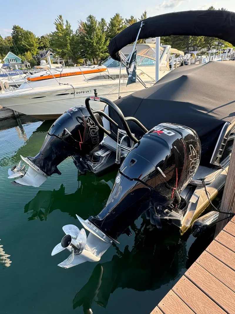 Slide: The Image of 2018 Crest Continental 270 NX-CS Twin with dual outboard motors docked at marina. - 24