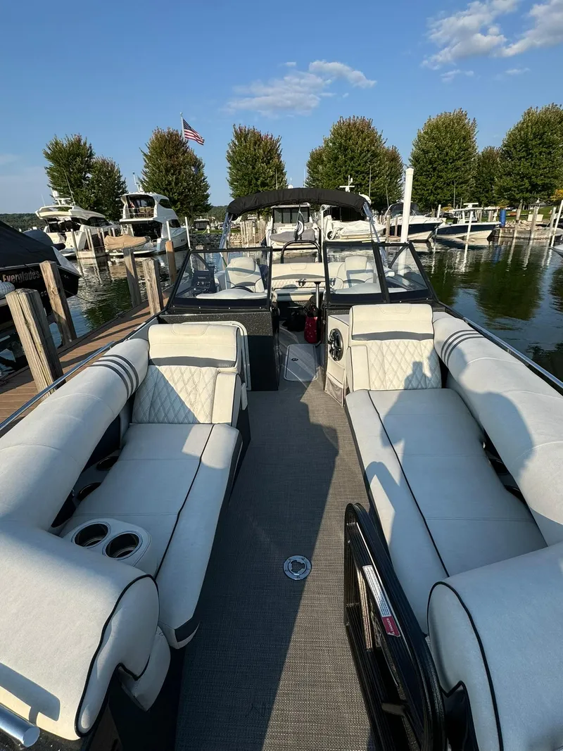 Slide: The Image of 2018 Crest Continental 270 NX-CS Twin boat with luxurious seating at a marina. - 25
