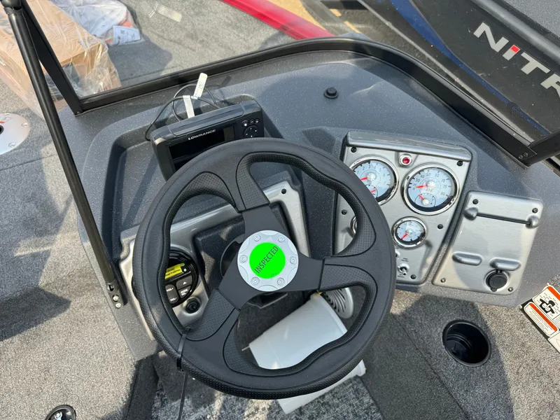 Slide: The Image of 2025 Tracker Pro Guide V-175 WT boat dashboard with steering wheel and gauges. - 16