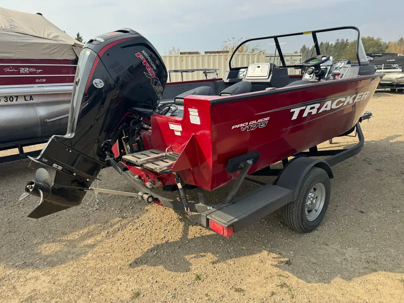 Slide: The Image of 2025 Tracker Pro Guide V-175 WT boat on trailer, red exterior, outboard motor. - 3