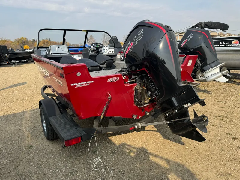 Slide: The Image of 2025 Tracker Pro Guide V-175 WT boat with powerful outboard motor, parked on a trailer. - 4