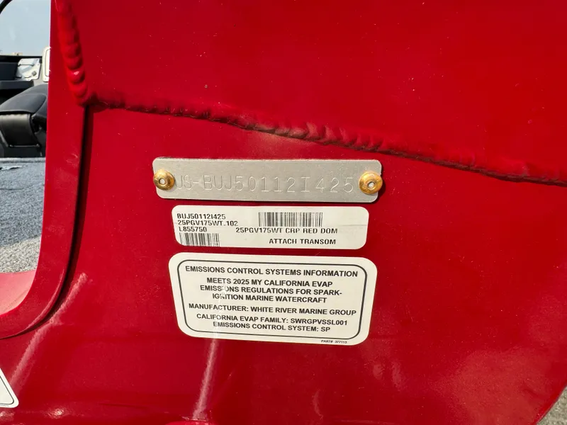 Slide: The Image of 2025 Tracker Pro Guide V-175 WT boat emissions control label on red surface. - 5