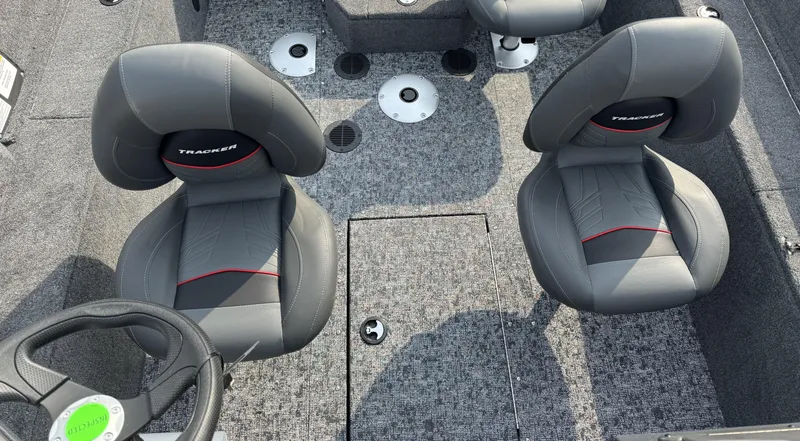 Slide: The Image of 2025 Tracker Pro Guide V-175 WT boat interior with two gray seats and steering wheel. - 9