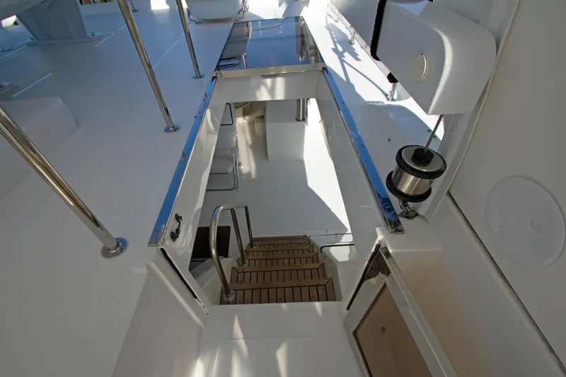 Slide: The Image of Stairway on 1999 Johnson 70 Motor Yacht, featuring sleek design and wooden steps. - 11