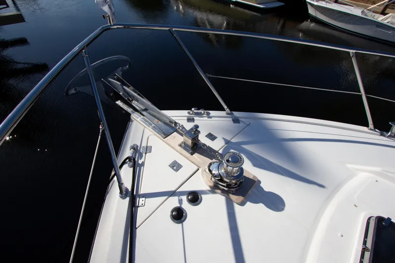 Slide: The Image of Bow of 1999 Johnson 70 Motor Yacht with anchor and railing. - 12