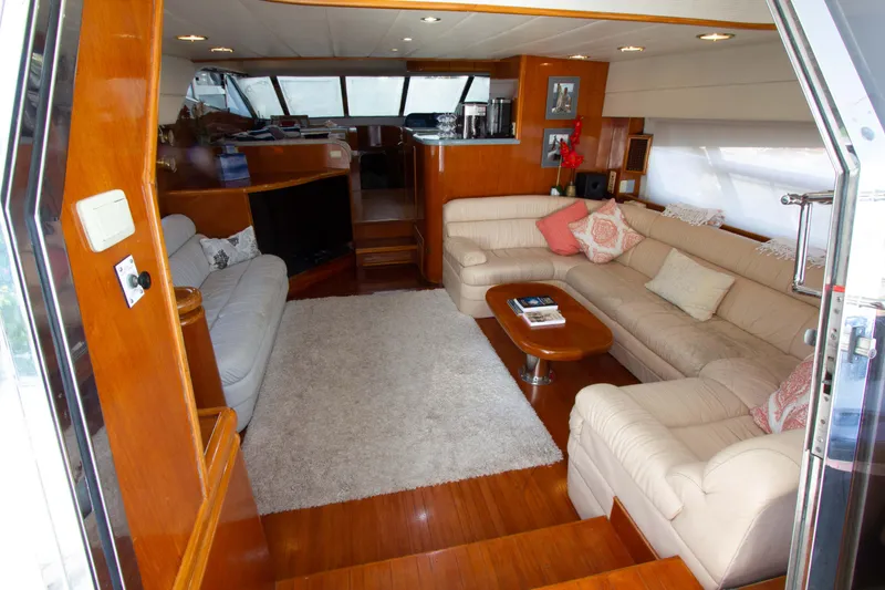 Slide: The Image of Luxurious interior of 1999 Johnson 70 Motor Yacht with plush seating and elegant wood finishes. - 15