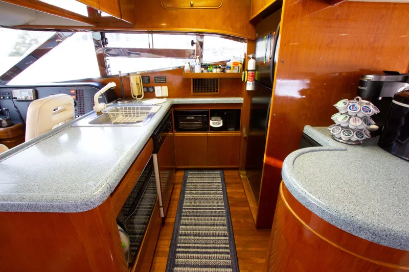 Slide: The Image of Luxurious kitchen interior of 1999 Johnson 70 Motor Yacht with modern amenities. - 19