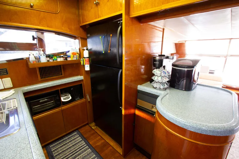 Slide: The Image of Cozy kitchen in 1999 Johnson 70 Motor Yacht with modern appliances and wood cabinetry. - 20