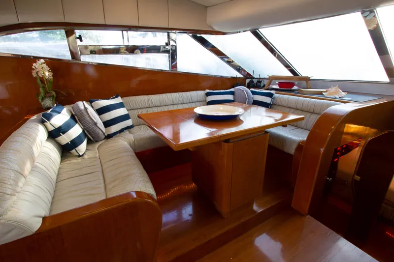 Slide: The Image of Luxurious interior of 1999 Johnson 70 Motor Yacht with elegant seating and dining area. - 21