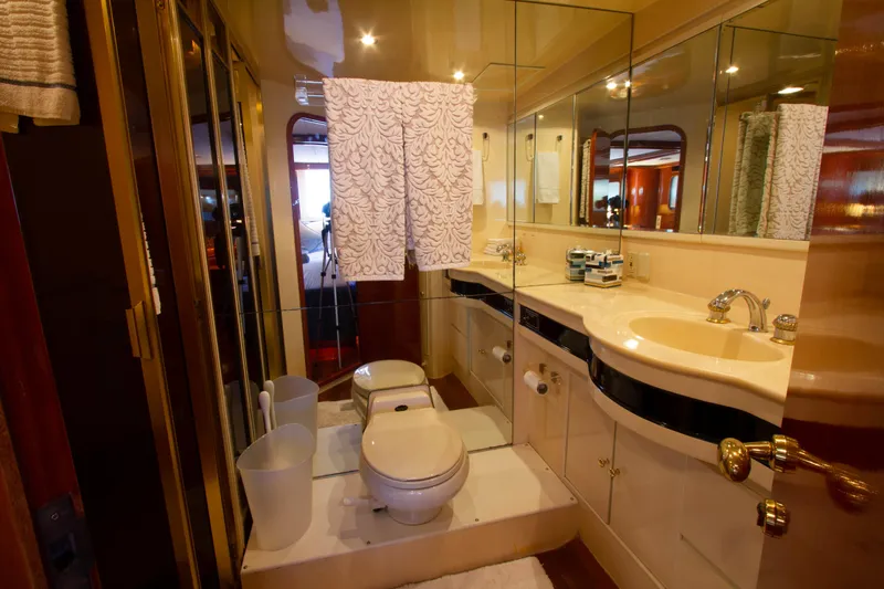 Slide: The Image of Luxurious bathroom in 1999 Johnson 70 Motor Yacht with elegant fixtures and mirrored walls. - 26