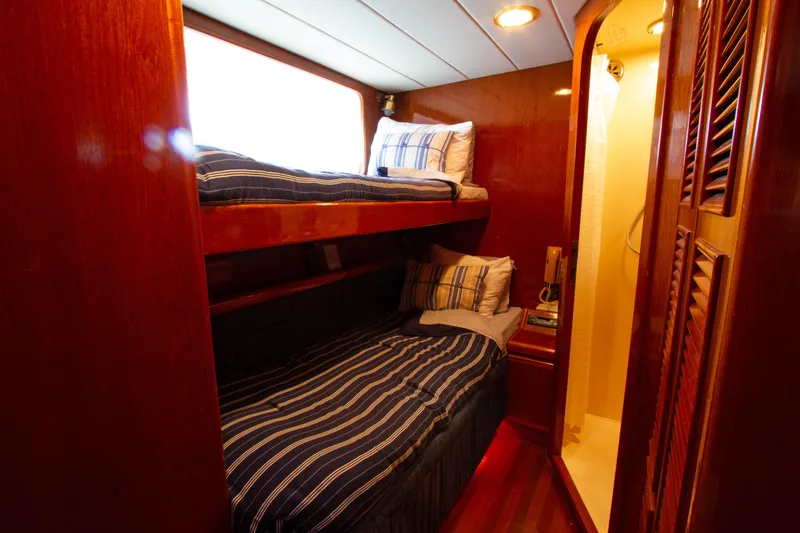 Slide: The Image of Cozy cabin with bunk beds on 1999 Johnson 70 Motor Yacht. - 28