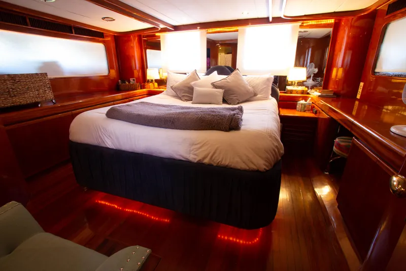 Slide: The Image of Luxurious bedroom interior of 1999 Johnson 70 Motor Yacht with elegant wood finishes. - 29