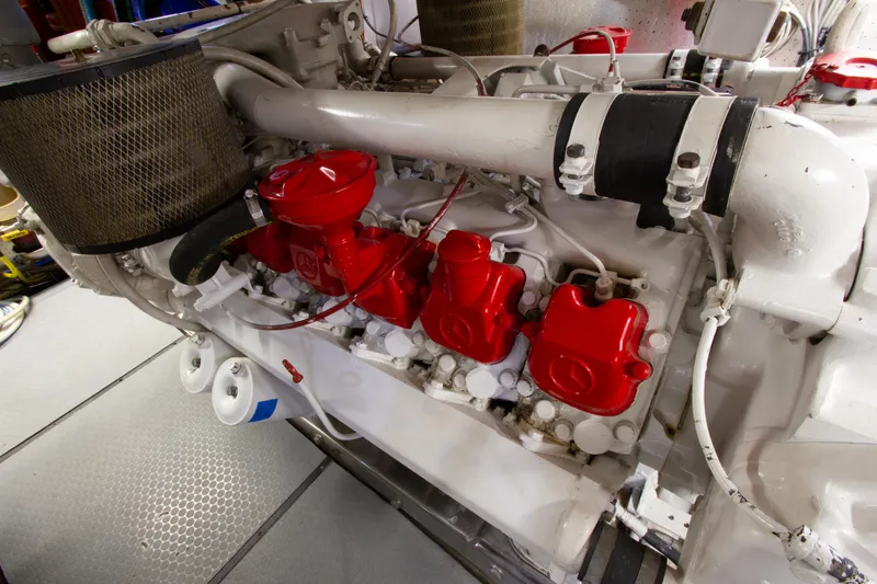 Slide: The Image of Engine room of 1999 Johnson 70 Motor Yacht with red and white components. - 33