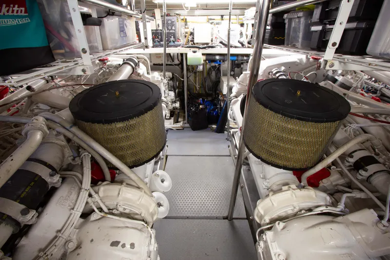 Slide: The Image of Engine room of 1999 Johnson 70 Motor Yacht with dual engines and storage. - 35