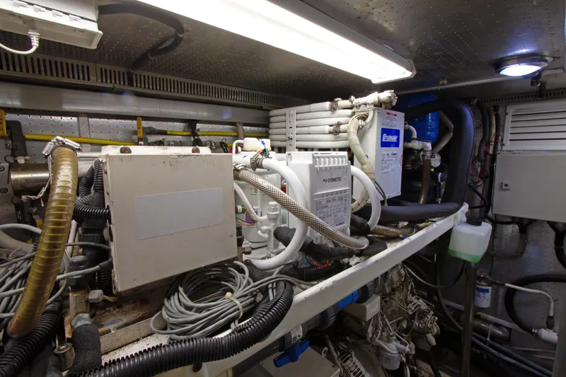 Slide: The Image of Engine room of 1999 Johnson 70 Motor Yacht with mechanical equipment and wiring. - 36