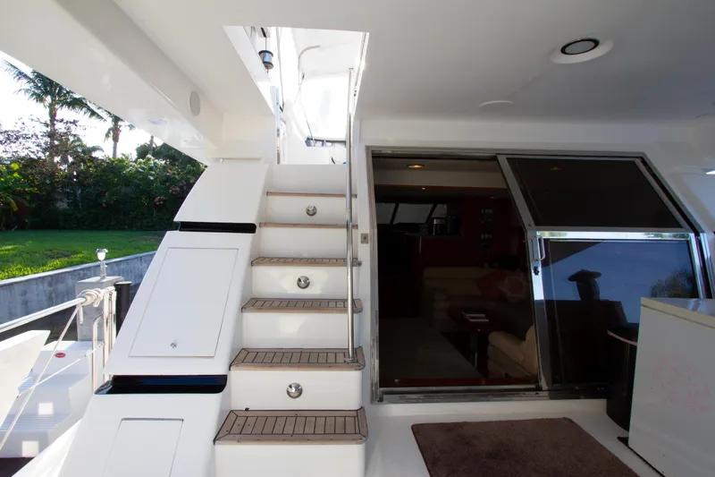 Slide: The Image of Interior view of 1999 Johnson 70 Motor Yacht with stairs and sliding door. - 6