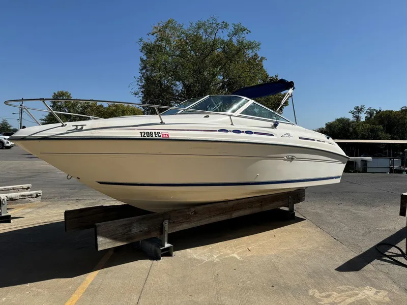 The Image of 1996 Sea Ray 215 Express Cruiser boat on display, white hull, outdoor setting. - 0