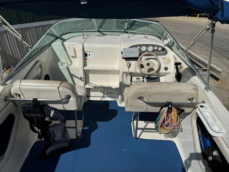 Slide: The Image of 1996 Sea Ray 215 Express Cruiser interior with steering wheel and seating. - 14