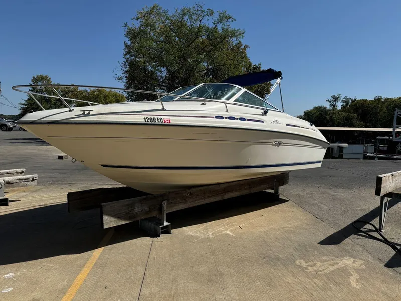 Slide: The Image of 1996 Sea Ray 215 Express Cruiser on display in a marina setting. - 2
