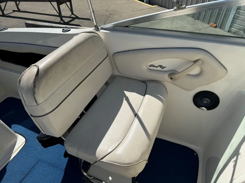 Slide: The Image of 1996 Sea Ray 215 Express Cruiser interior with white seating and blue carpet. - 20