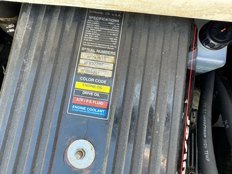 Slide: The Image of Engine compartment of 1996 Sea Ray 215 Express Cruiser with specifications and color-coded labels. - 24