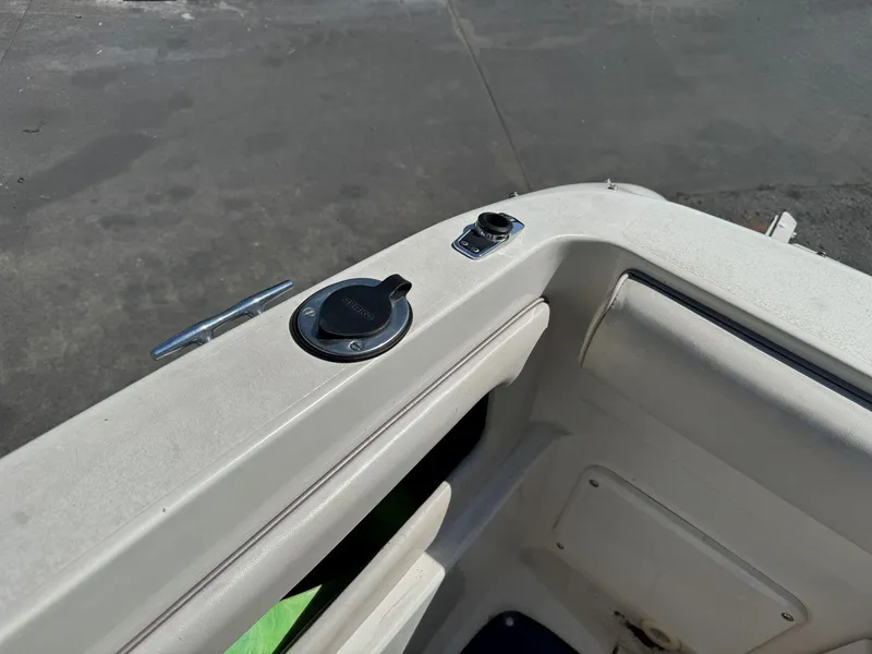 Slide: The Image of 1996 Sea Ray 215 Express Cruiser boat interior detail with cup holder and cleat. - 27