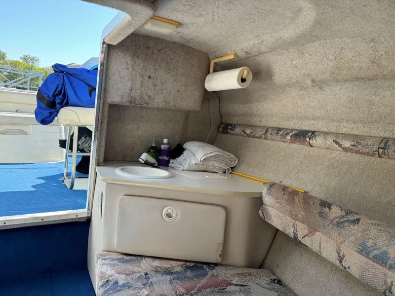Slide: The Image of Interior cabin of 1996 Sea Ray 215 Express Cruiser with sink and seating. - 30