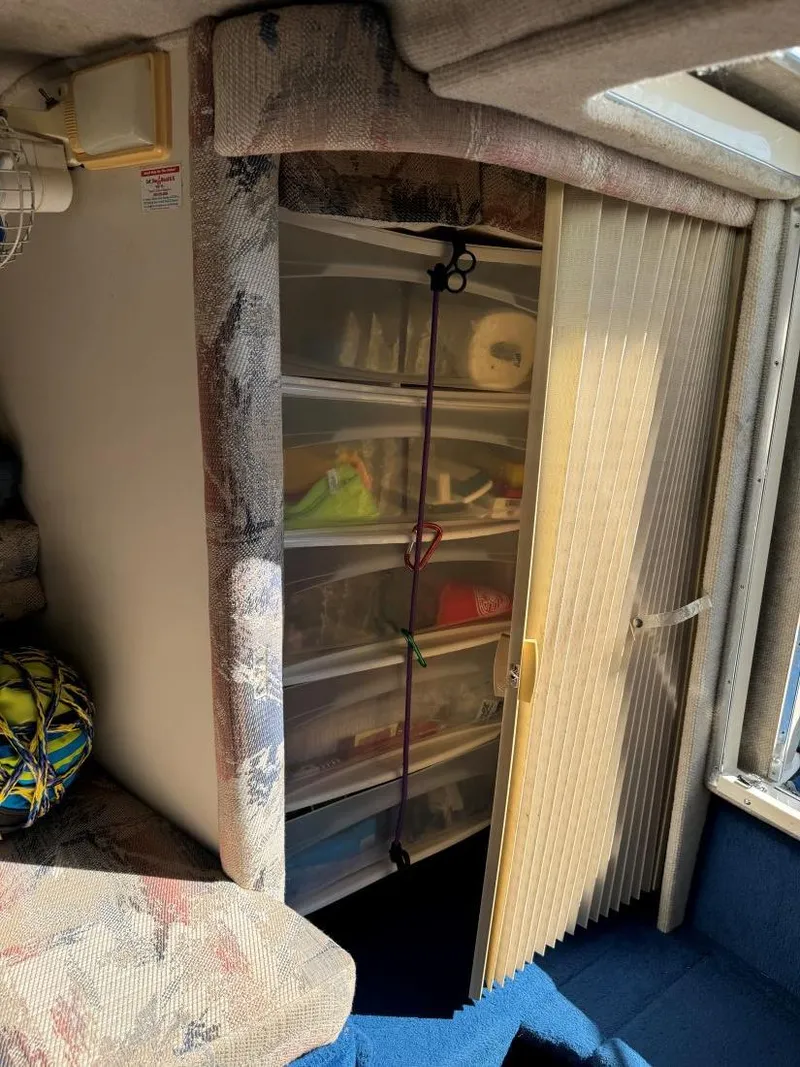 Slide: The Image of Interior storage area of 1996 Sea Ray 215 Express Cruiser with organized shelves. - 31