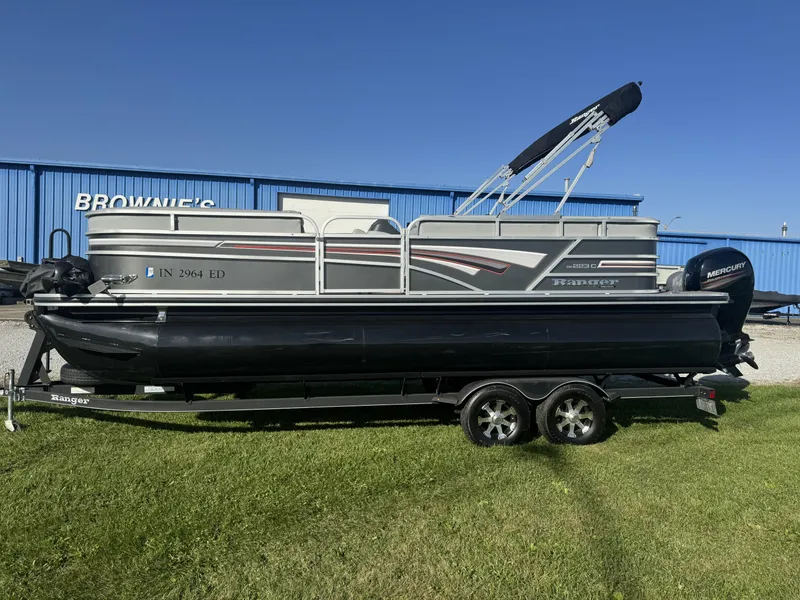 The Image of 2019 Ranger Reata 223C pontoon boat on trailer, parked on grass. - 0