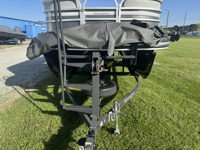 Slide: The Image of 2019 Ranger Reata 223C boat on trailer, parked on grass. - 2