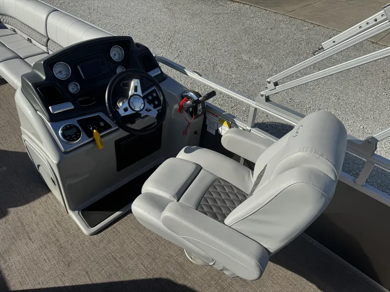 Slide: The Image of 2019 Ranger Reata 223C boat cockpit with steering wheel and captain's chair. - 5