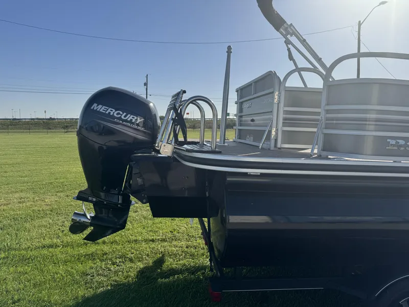 Slide: The Image of 2019 Ranger Reata 223C boat with Mercury outboard motor on grassy field. - 7
