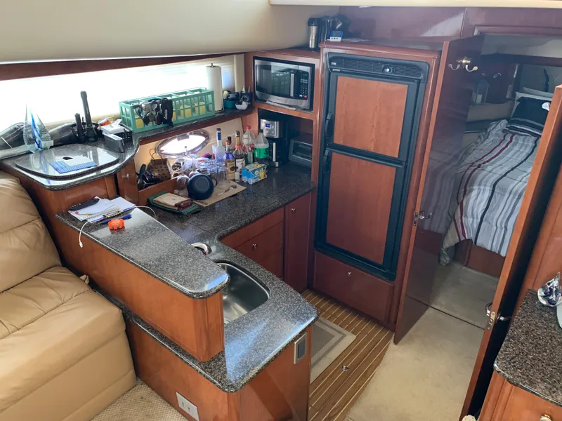 Slide: The Image of Interior of 2006 Meridian 459 Motoryacht with kitchenette and cozy cabin space. - 10