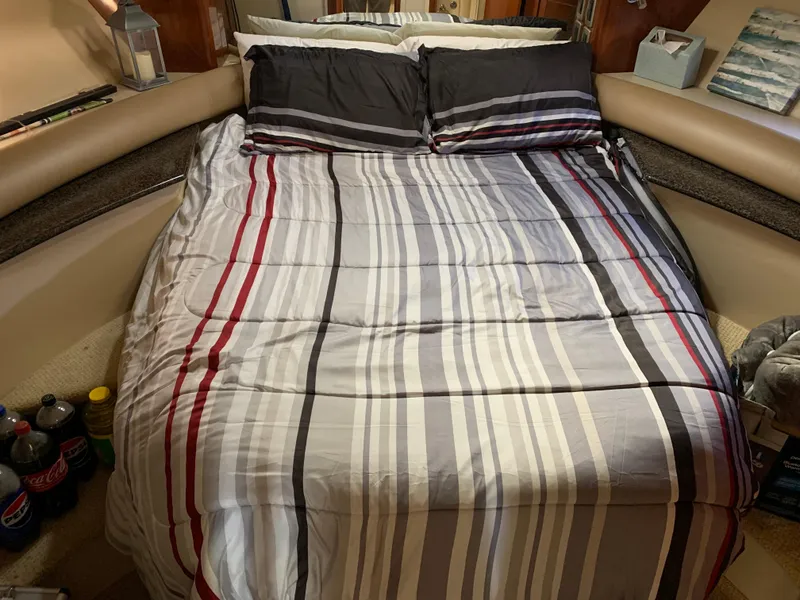 Slide: The Image of Cozy bedroom in 2006 Meridian 459 Motoryacht with striped bedding and pillows. - 14