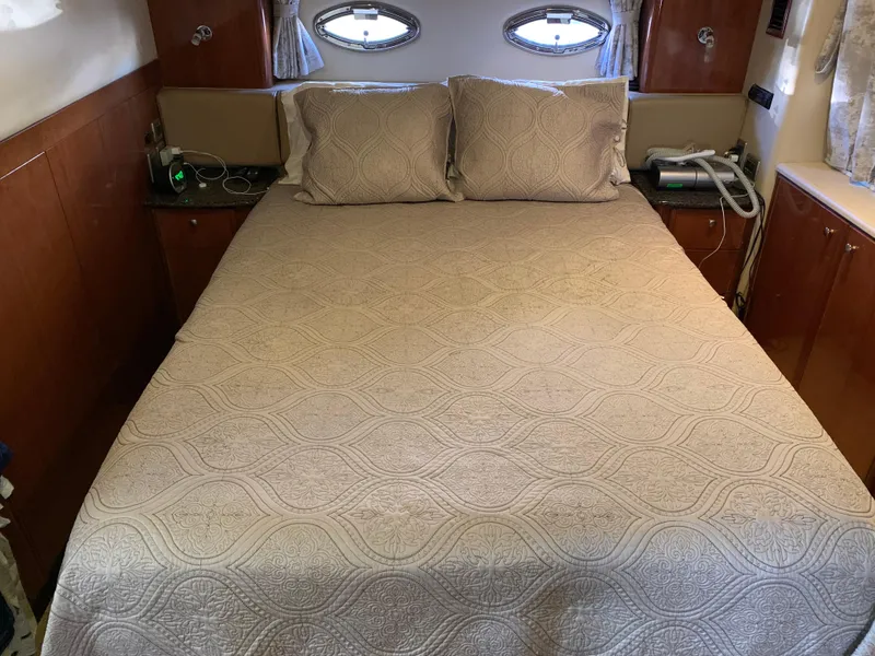 Slide: The Image of Cozy bedroom in 2006 Meridian 459 Motoryacht with elegant bedding and wooden accents. - 16