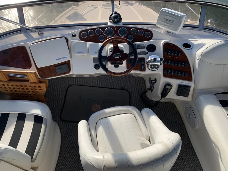 Slide: The Image of 2006 Meridian 459 Motoryacht helm with leather seats and navigation controls. - 2
