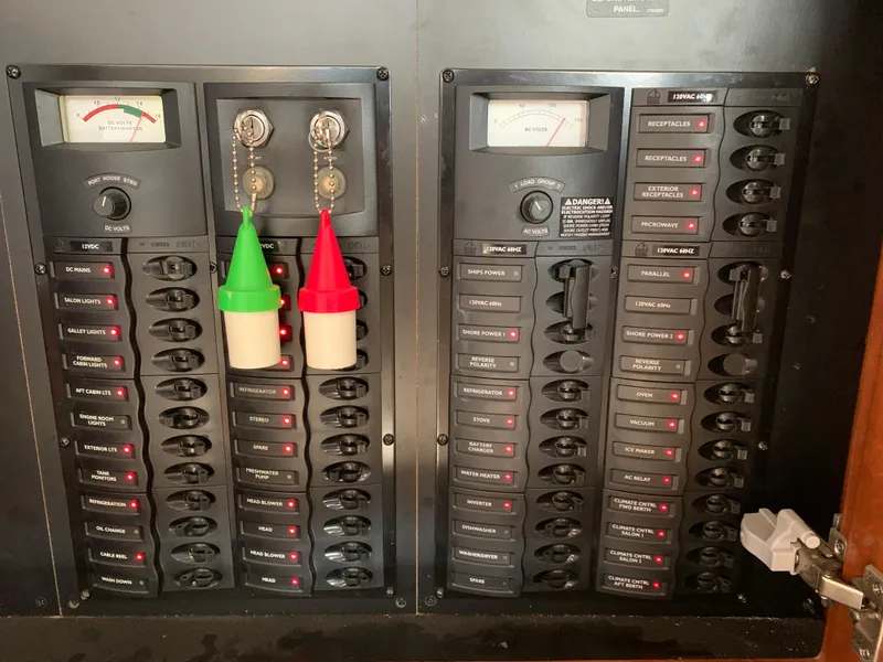 Slide: The Image of Electrical panel of 2006 Meridian 459 Motoryacht with labeled switches and meters. - 20