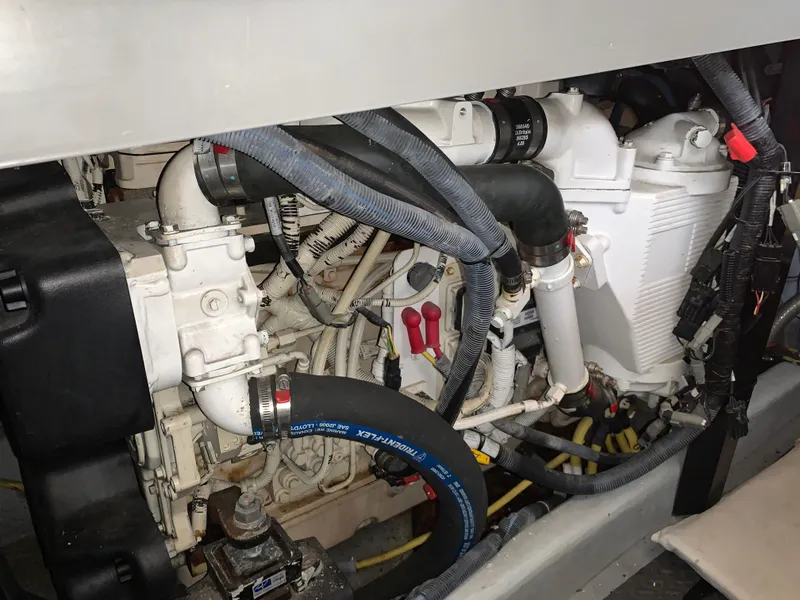Slide: The Image of Engine compartment of 2006 Meridian 459 Motoryacht with visible hoses and components. - 25