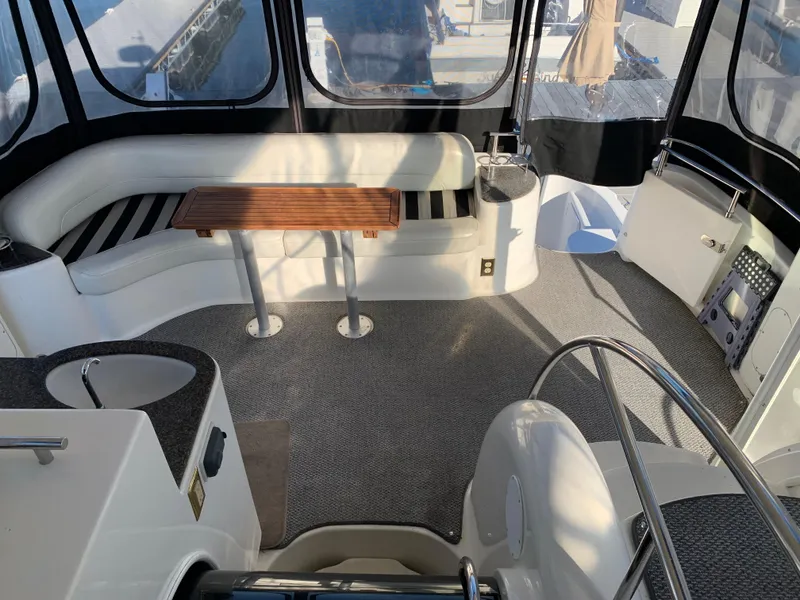 Slide: The Image of 2006 Meridian 459 Motoryacht interior with seating and table, featuring panoramic windows. - 5