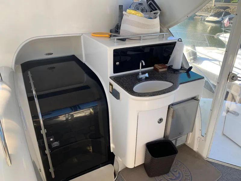 Slide: The Image of 2006 Meridian 459 Motoryacht kitchenette with sink, storage, and outdoor view. - 6