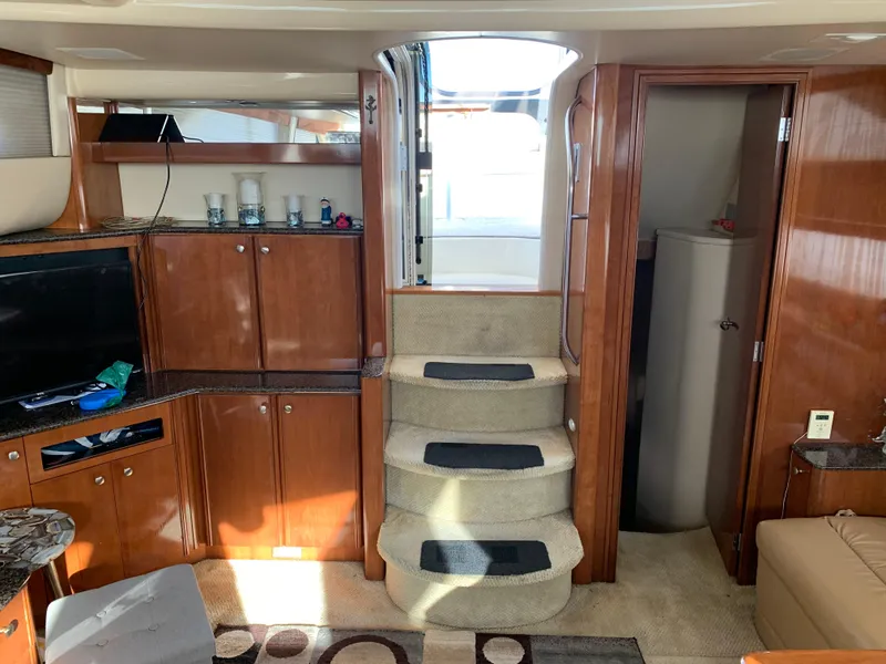 Slide: The Image of Interior of 2006 Meridian 459 Motoryacht with wooden cabinetry and carpeted stairs. - 9