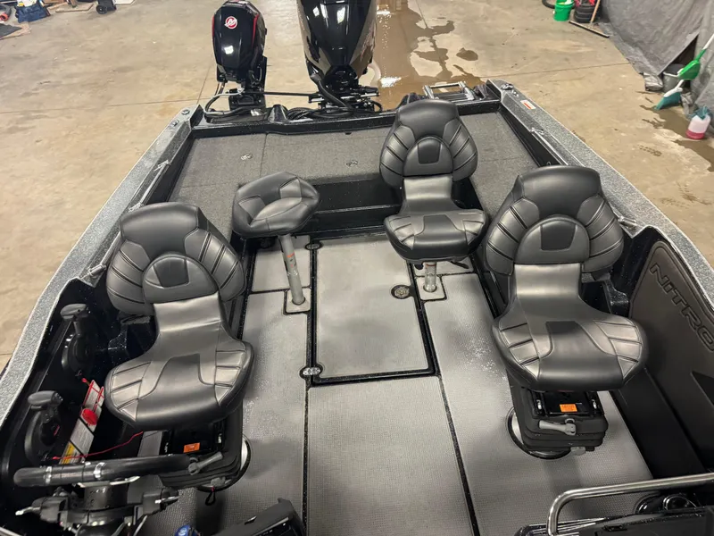 Slide: The Image of 2022 Nitro ZV20 boat interior with four black seats and dual motors. - 18