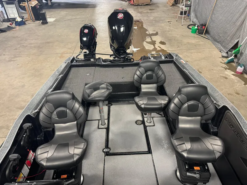 Slide: The Image of 2022 Nitro ZV20 boat interior with four black seats and dual outboard motors. - 19