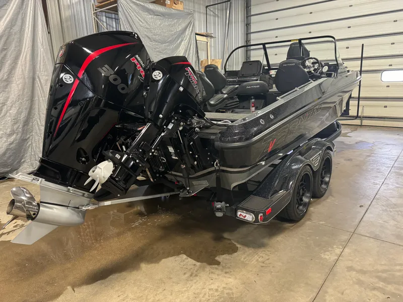 Slide: The Image of 2022 Nitro ZV20 boat with dual engines in a garage setting. - 3