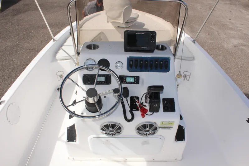 Slide: The Image of 2002 Cobia 191 Bay boat console with steering wheel and navigation equipment. - 11