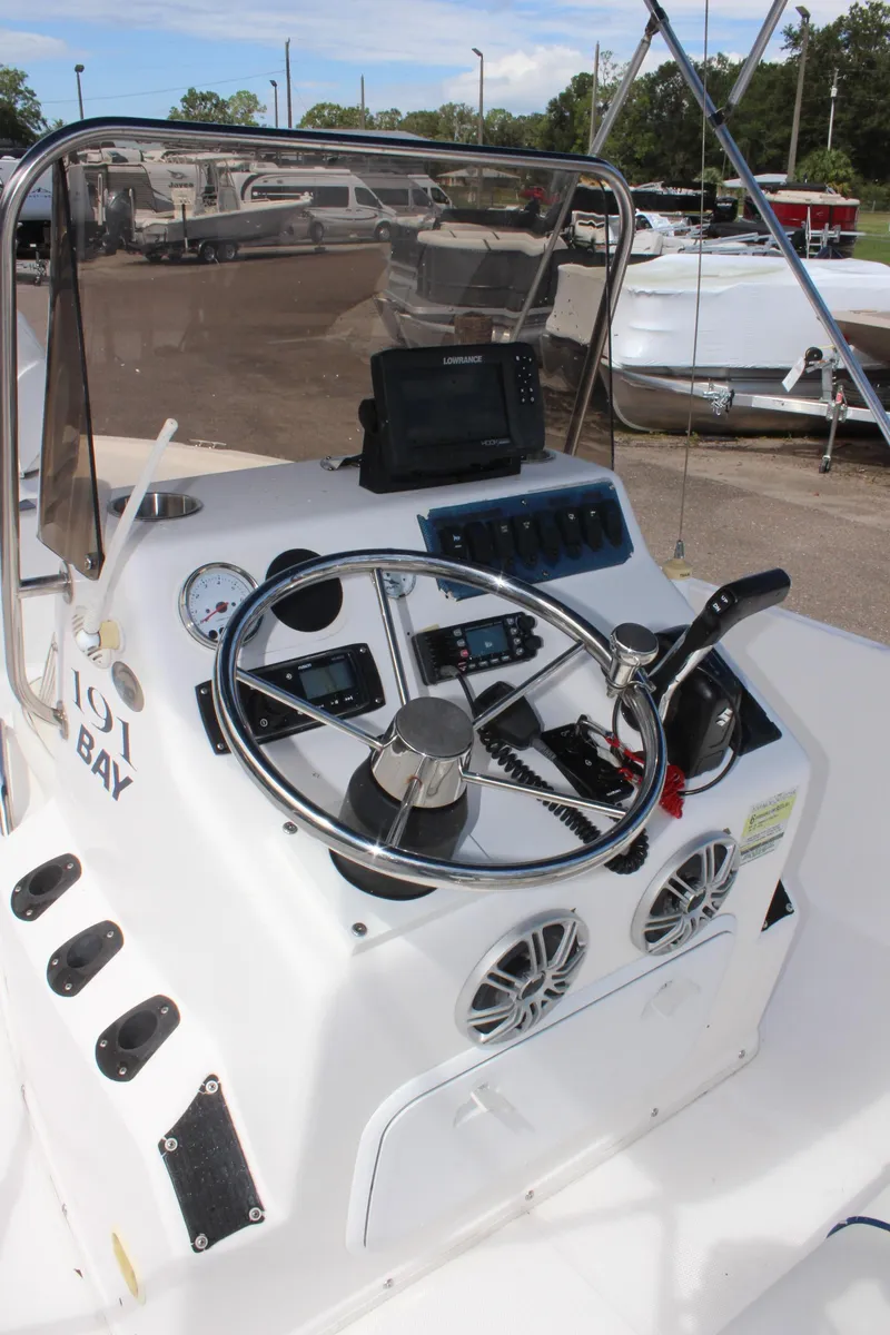 Slide: The Image of 2002 Cobia 191 Bay boat dashboard with steering wheel and controls. - 12