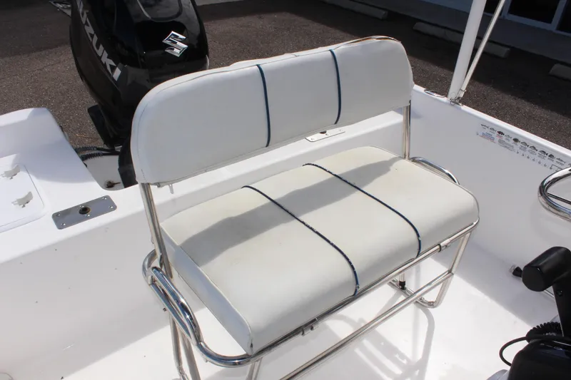 Slide: The Image of 2002 Cobia 191 Bay boat seat with white upholstery and metal frame. - 13