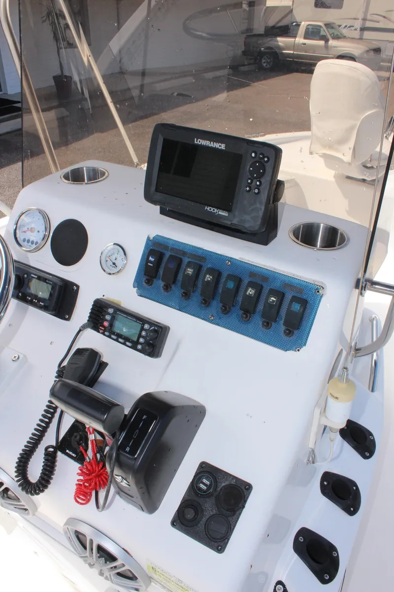 Slide: The Image of 2002 Cobia 191 Bay boat dashboard with navigation equipment and controls. - 14