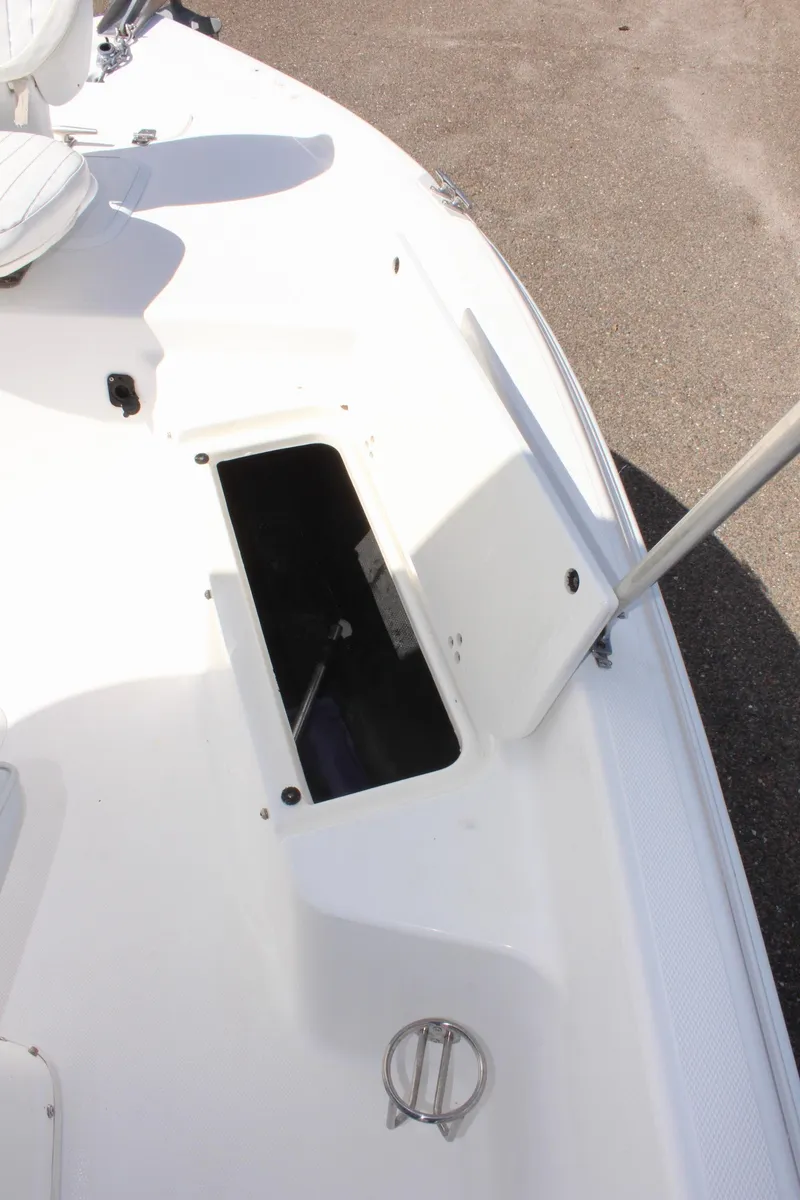 Slide: The Image of 2002 Cobia 191 Bay boat deck with open storage compartment. - 19